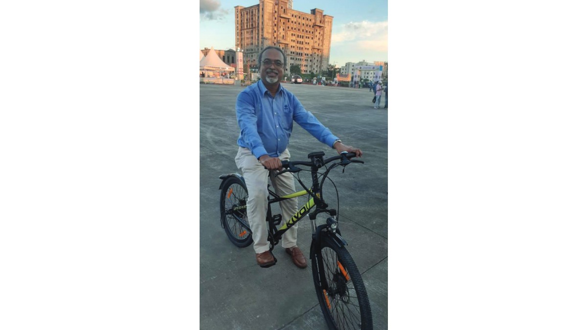 Mr. Abraham Stephanos, President, The Bengal Chamber of Commerce and Industry riding an electric bicycle